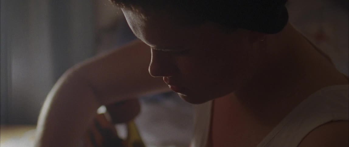 A young boy fixes the wheel on a skateboard