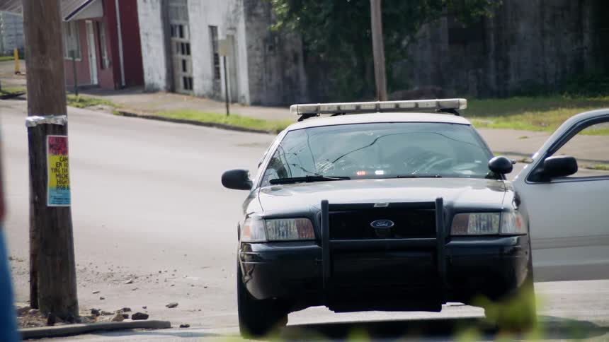 The police car is parked with it's lights flashing