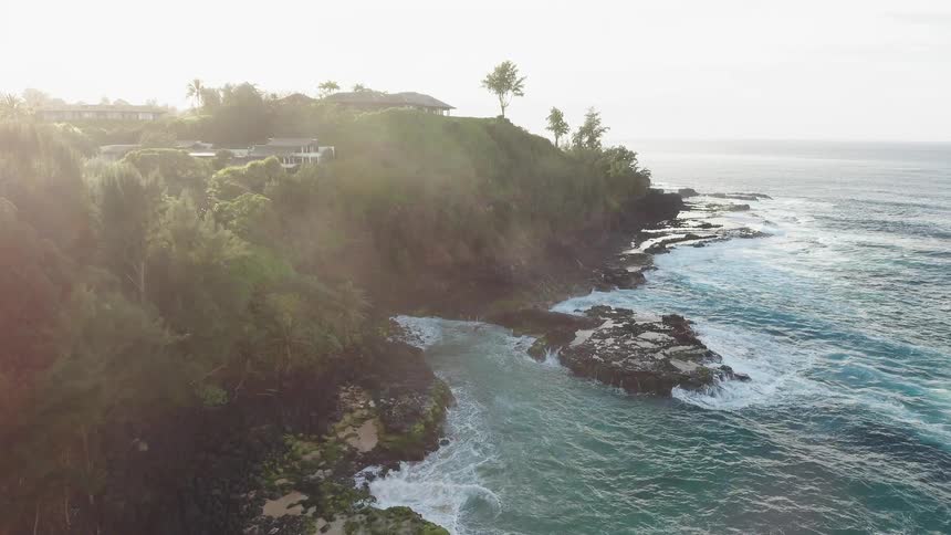 Water crashes to shore and sun shines down