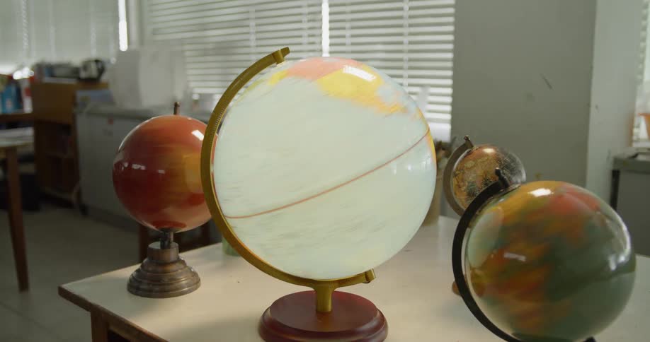 The globes on the table are spinning