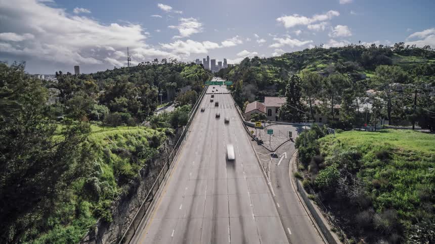 Some of the cars exit the highway on the right