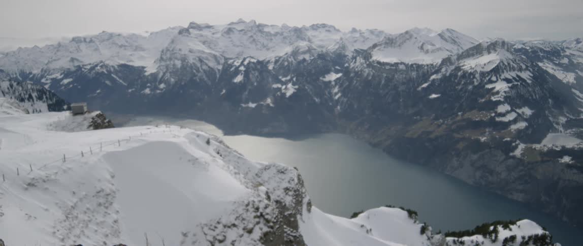 Snow covered ridges overlooking a lake