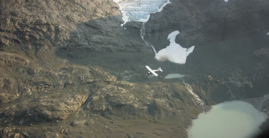 The plane is traveling over the mountain range
