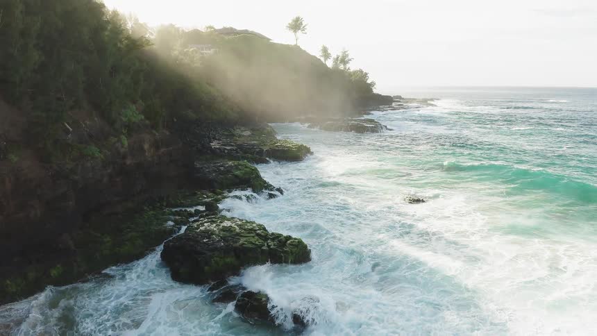 Ocean waves splash and break against the rocky shore