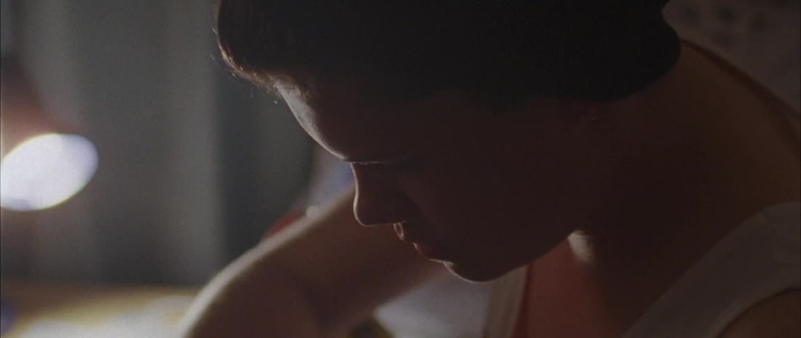 A boy is repairing his skateboard