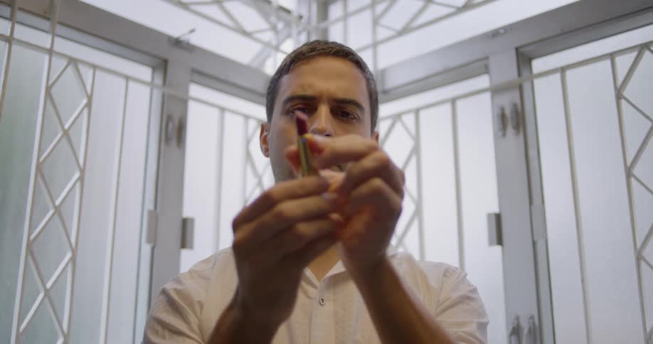 A man closes a lipstick tube