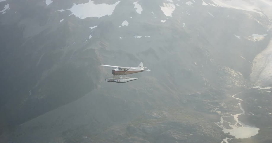 The plane glides over the mountain range