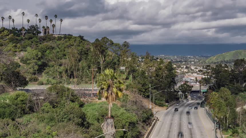 The cars travel down the winding road together