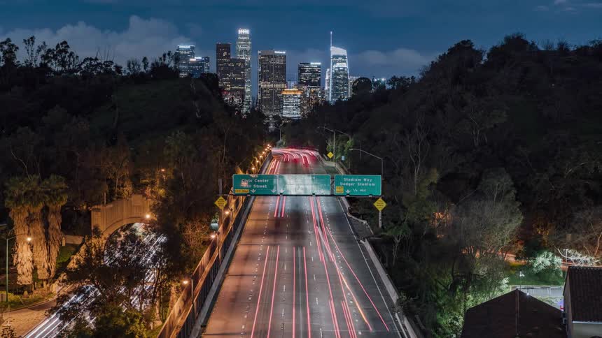 The highway is very busy lit up from the cars traveling