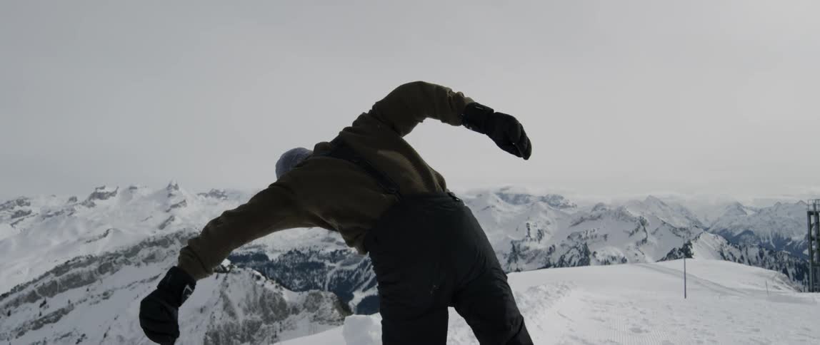 A man runs and flips into the snow
