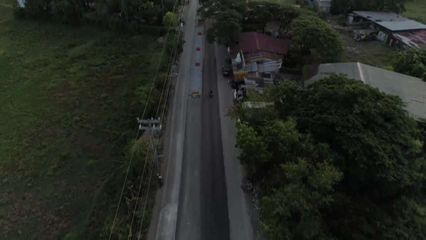 A person travels on their vehicle down the road