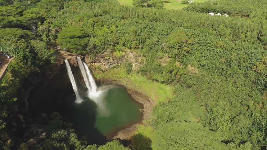 Water falls off the side of a stone cliff