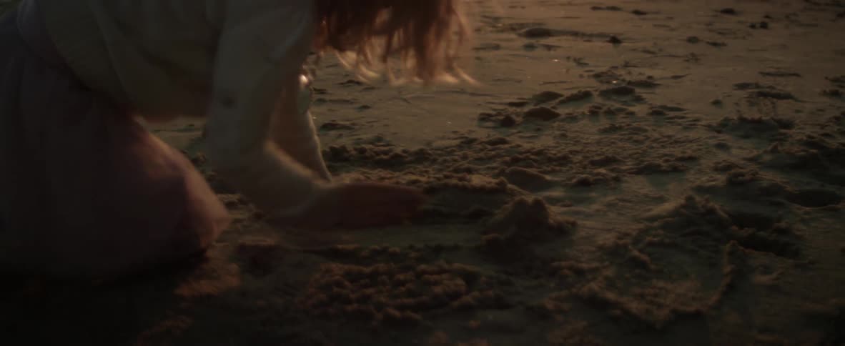 Girl playing around in the sand