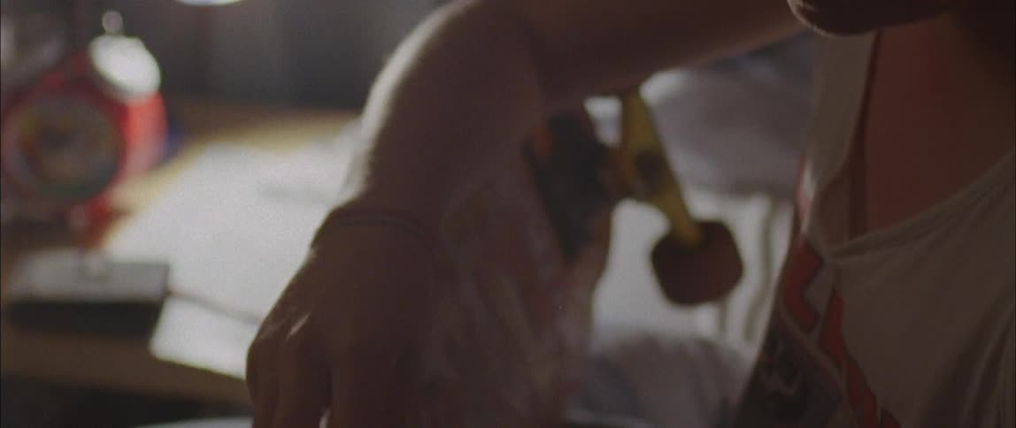 A young boy tights the wheel on his skateboard