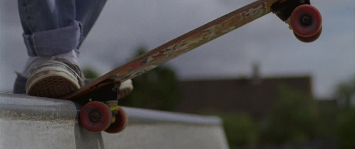A person rides their skateboard on the ramp