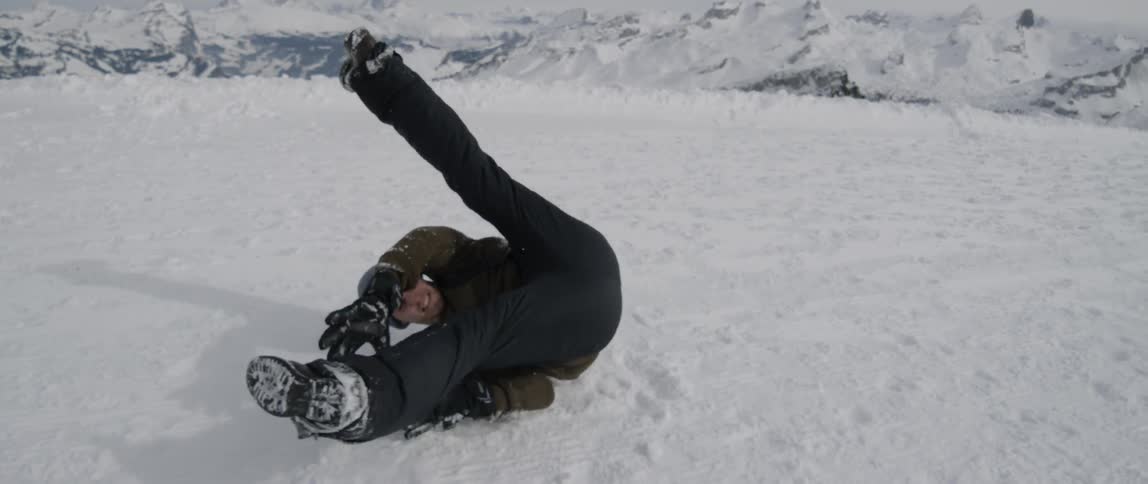 A man break dances in snowy mountains