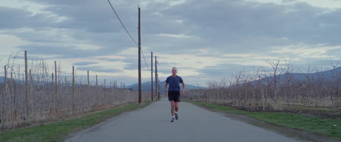 A man jogs on a rural road