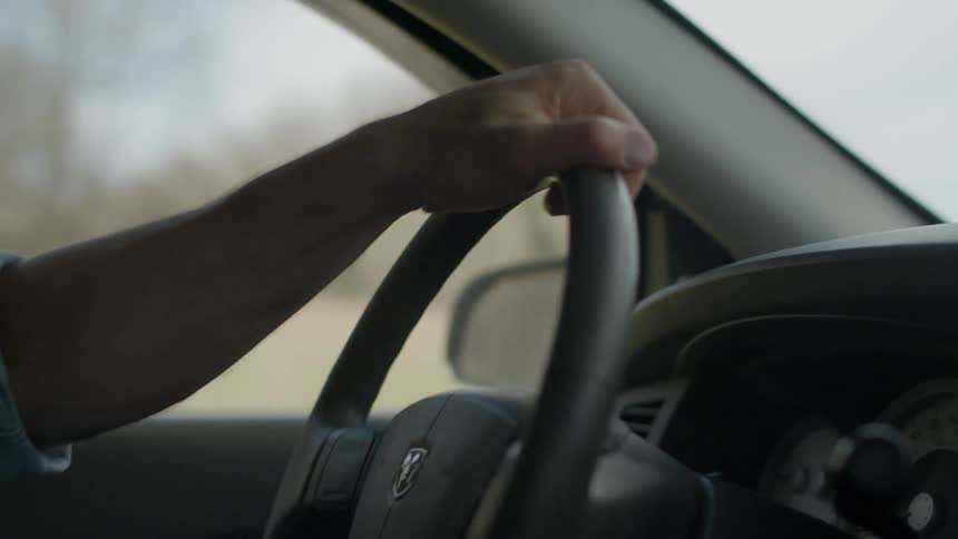 A person turns the wheel sharply as they drive
