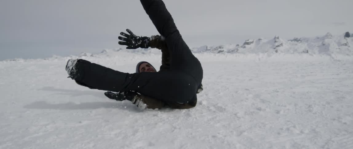 A man is breakdancing in the snow