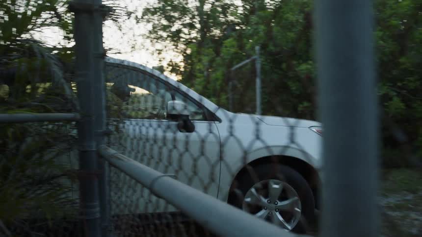 An suv drives onto a lawn
