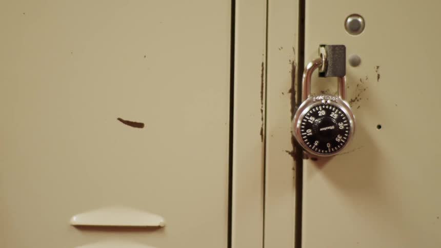 A padlock hangs on a locker door