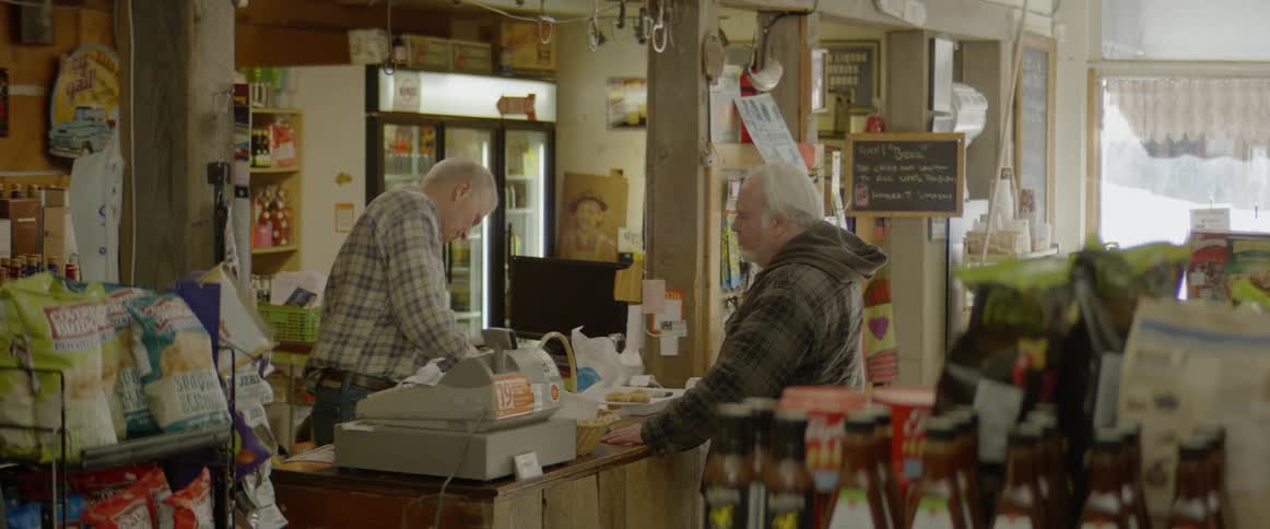 A man goes to the register to purchase something
