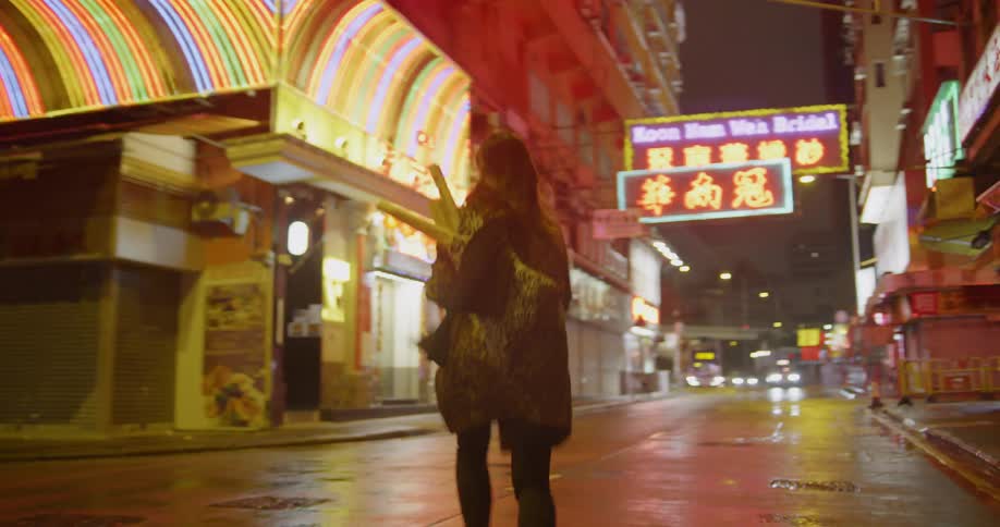 A woman runs across a city street