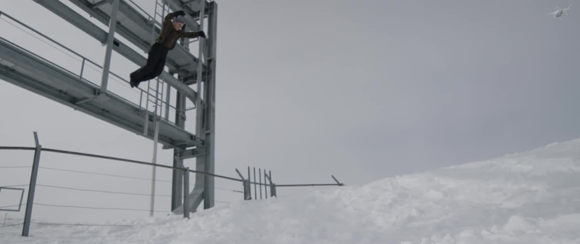 A man jumps off the platform into the snow