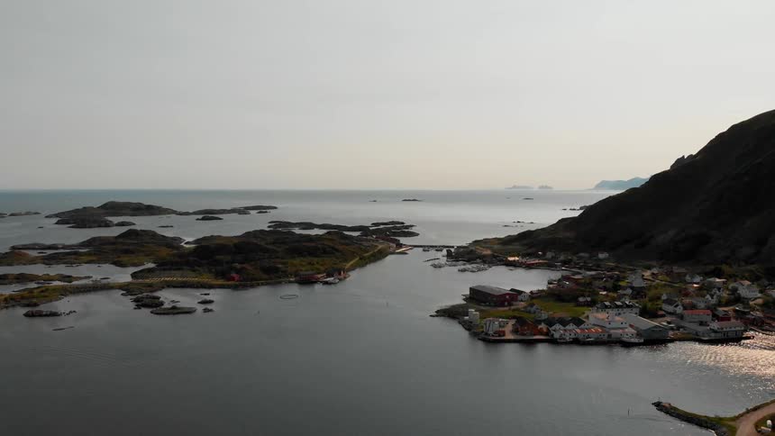 A town rests on the shore below a mountain