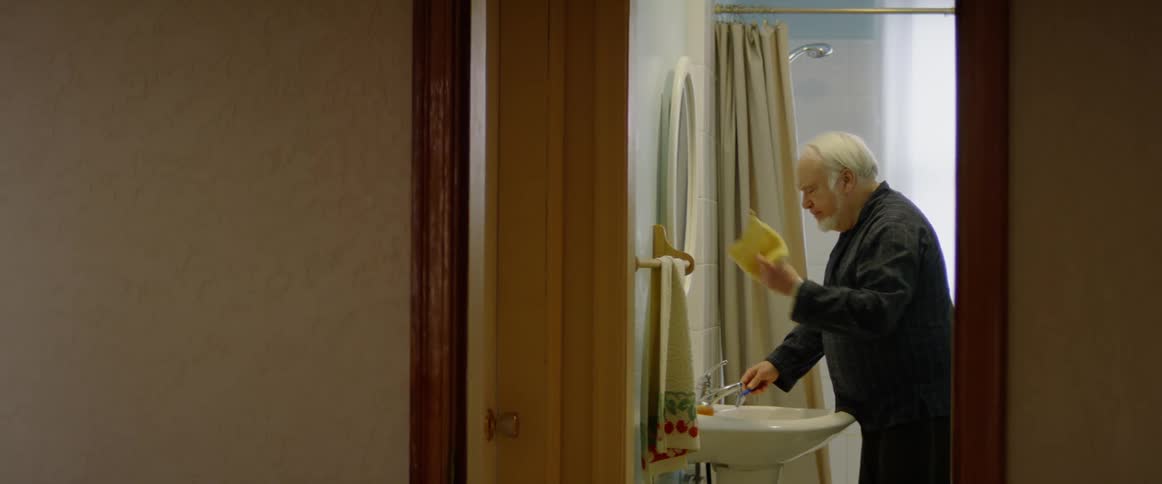 Person washes their hands in a bathroom sink