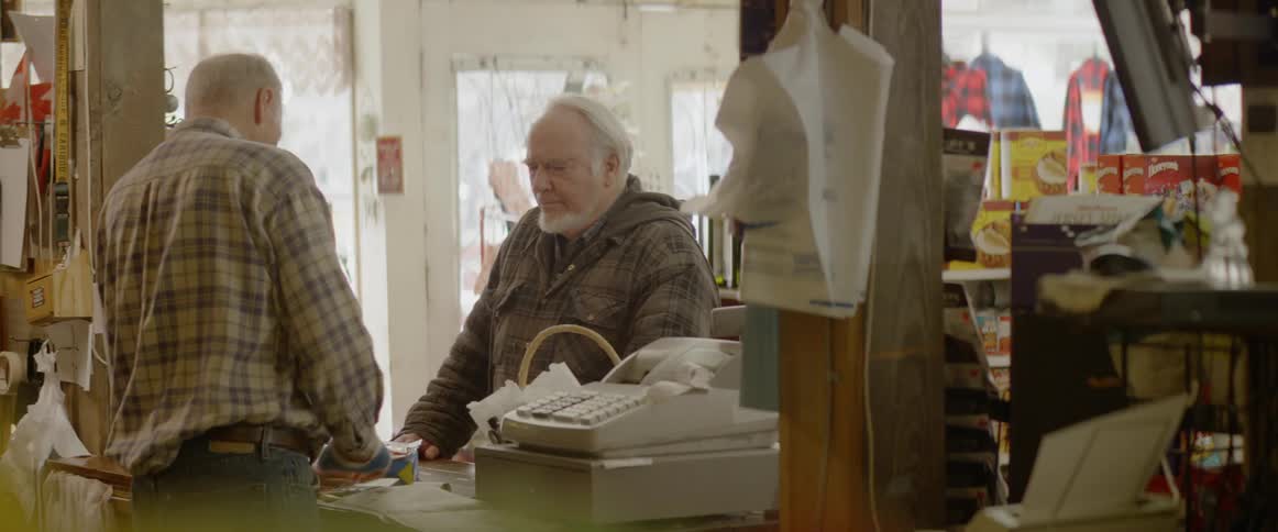 A man goes to the register to pay for his goods