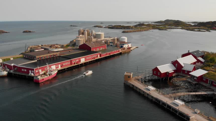 The boat sails around the pier in the water