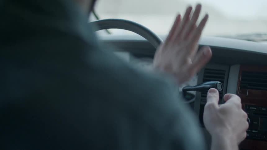 A person is spinning the wheel as they drive