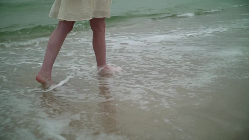 A woman walks on the beach