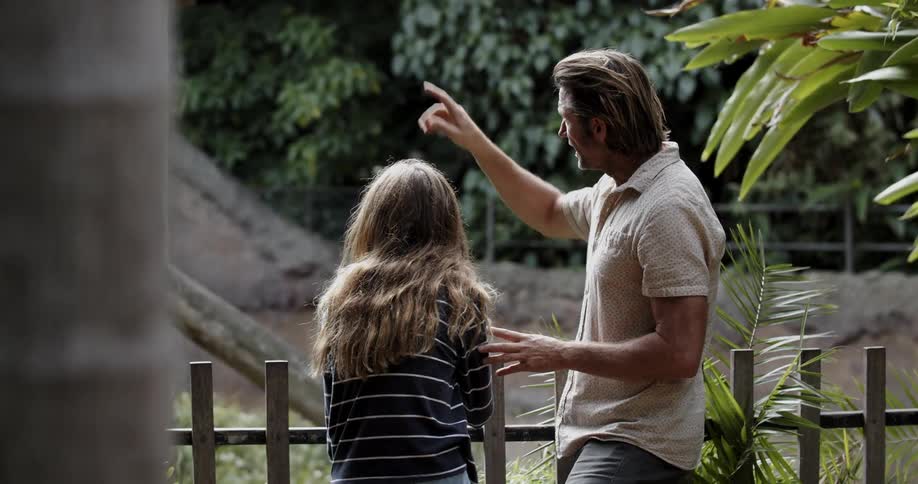 A dad points things out to his daughter while he talks