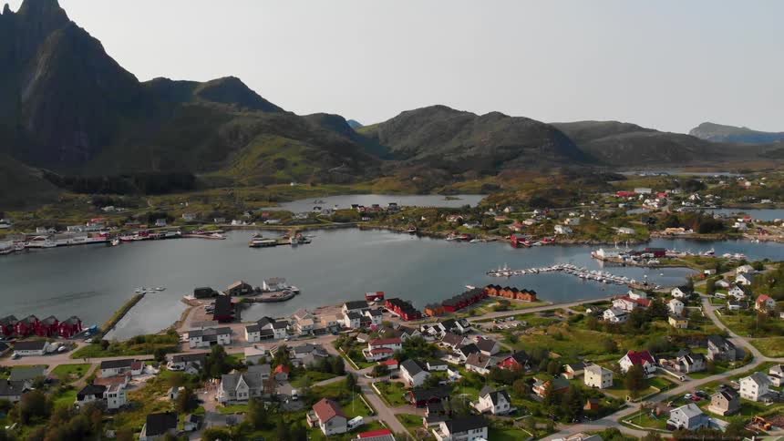 A coastal town sits at the foot of the mountain