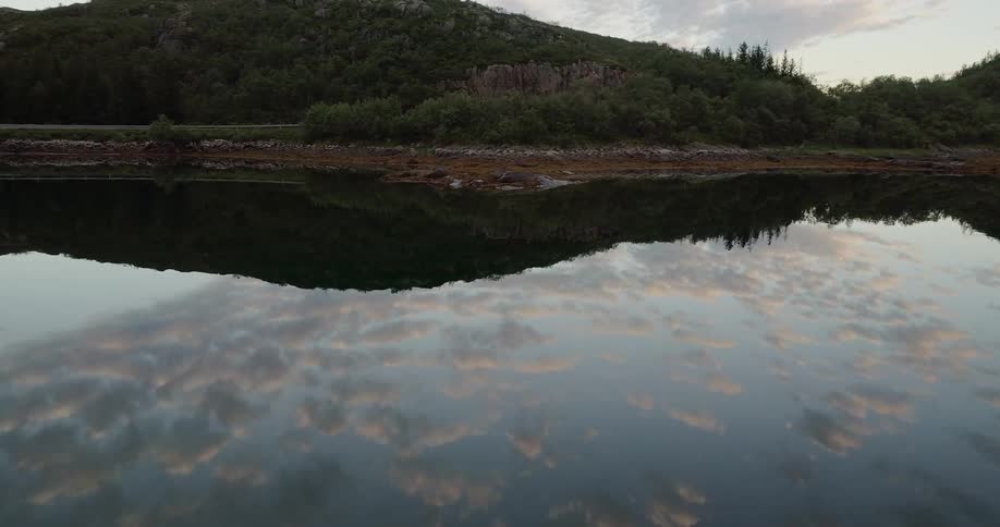 The water near the shore is reflective and calm