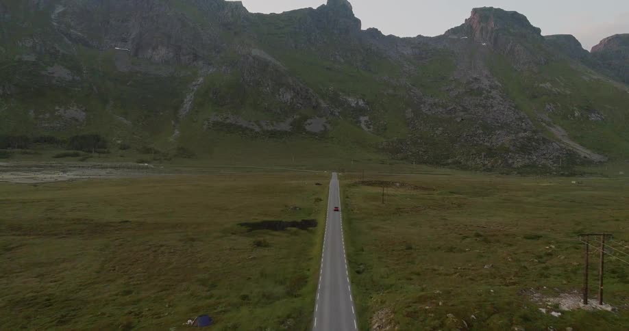 Vehicle travels down a highway towards the mountains