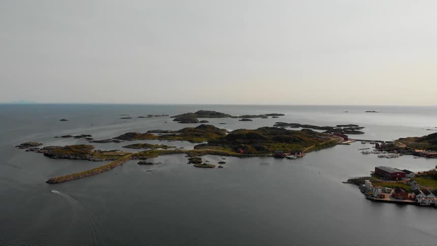 A boat sales past the islands below
