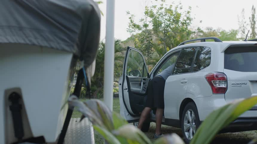 Man leans into a parked car