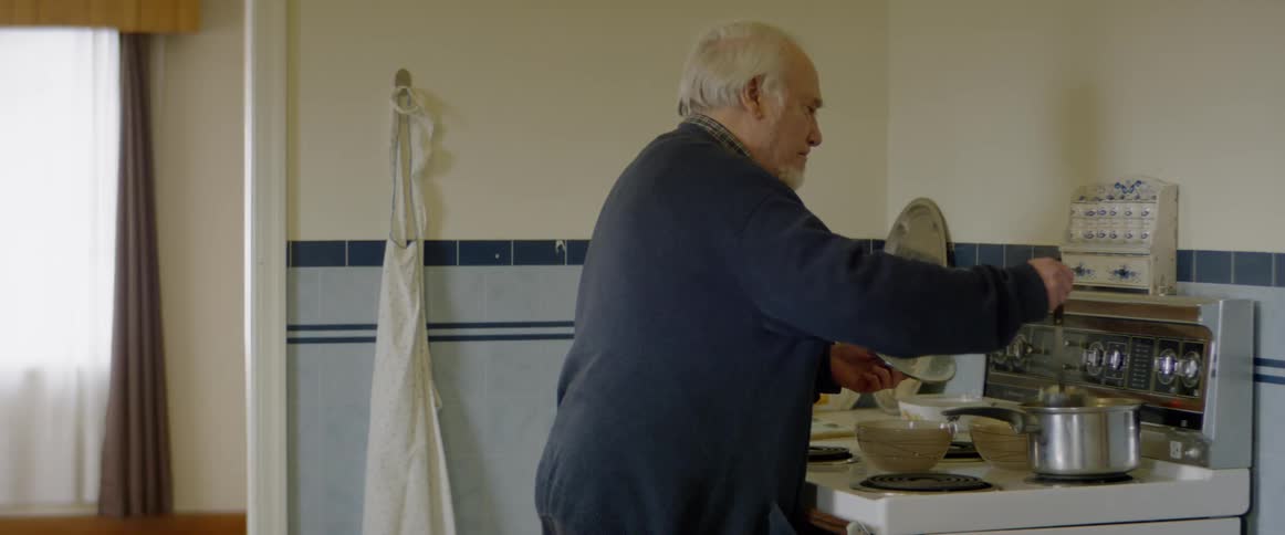 A man cooks on the stove