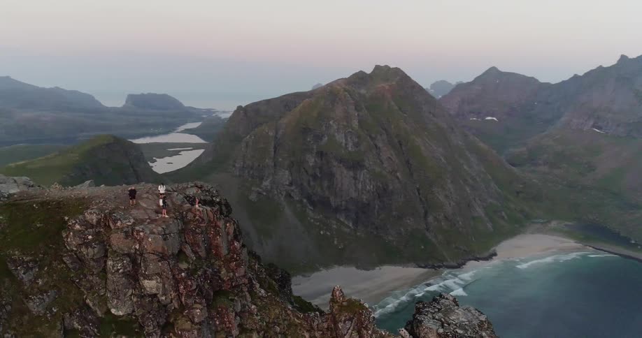 Mountains stand tall next to a lake