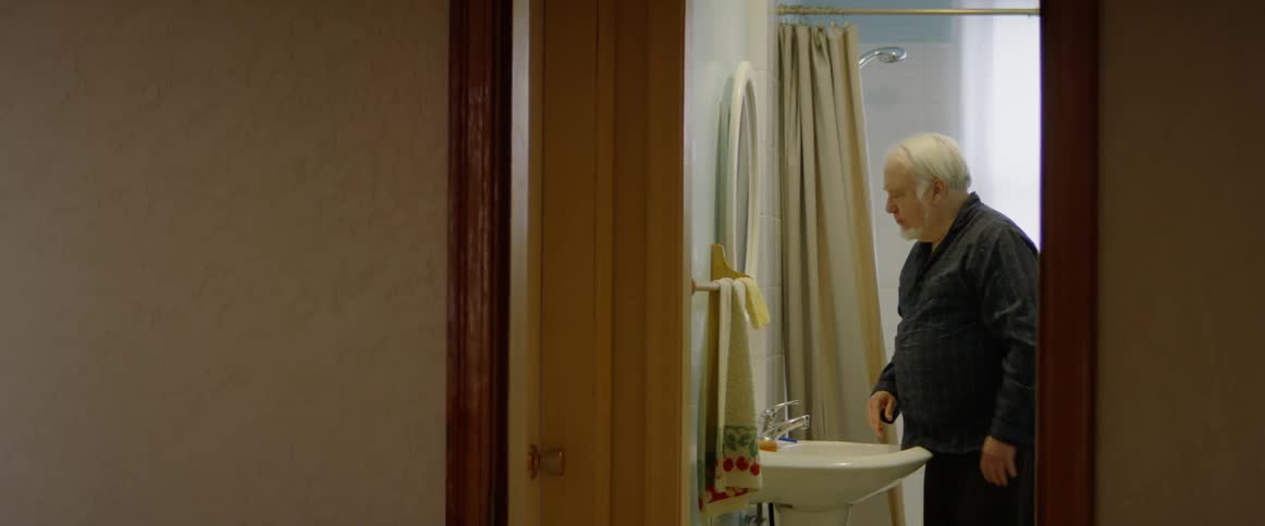 A man washes his face with a washcloth