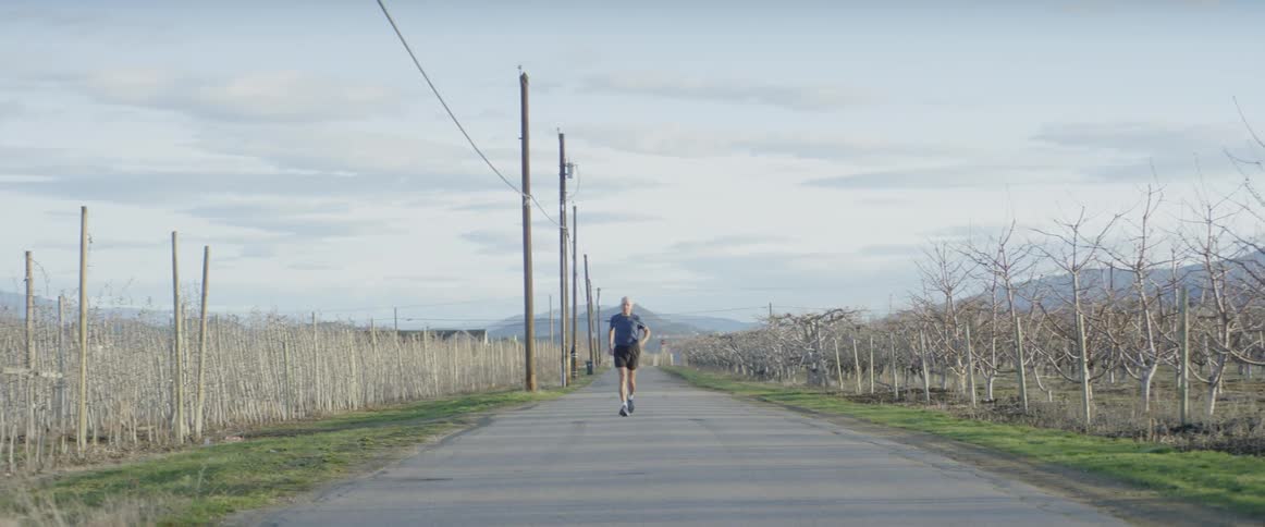 Man jogs on a rural road