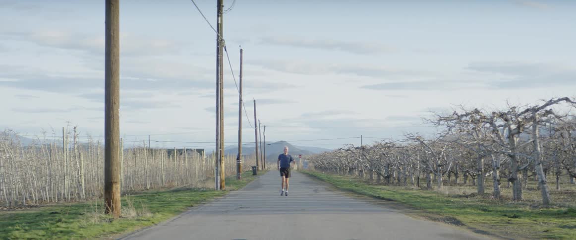 A man jogs on a rural road