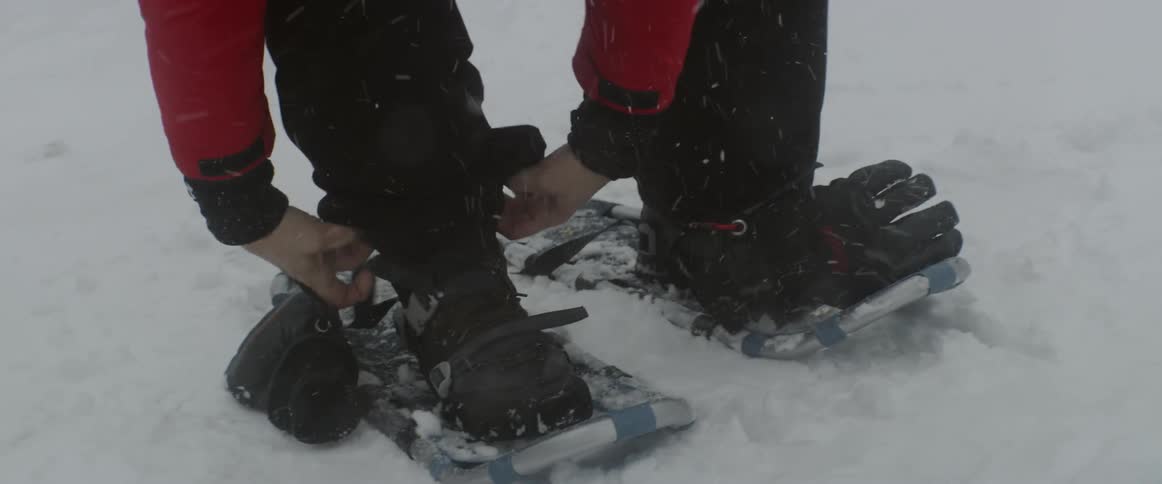 Man goes snowshoeing during a storm