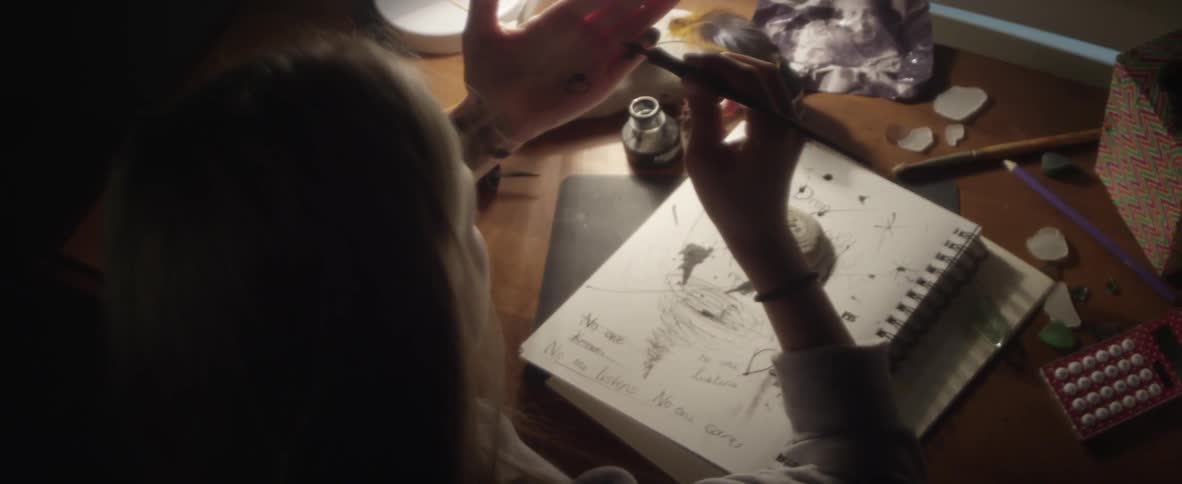 A girl draws on herself