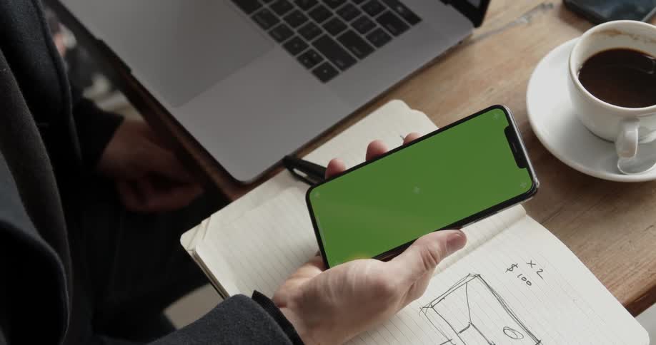 A person in an office looks at a phone