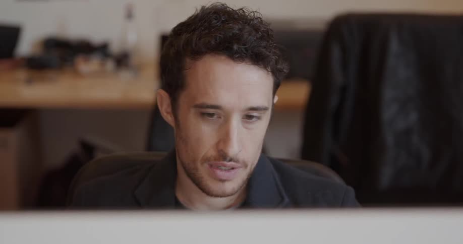 Man works in on a computer in an office