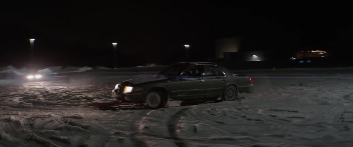 A car spins on the snow in the dark